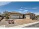 Attractive single-story home with a three-car garage, desert landscaping, and a tile roof under a blue sky at 2743 Evergreen Oaks Dr, Henderson, NV 89052