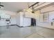 Spacious garage featuring epoxy floors and built-in white cabinets for storage at 2743 Evergreen Oaks Dr, Henderson, NV 89052