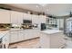 Bright kitchen features white cabinets, stainless steel appliances, and tile backsplash at 2743 Evergreen Oaks Dr, Henderson, NV 89052