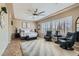 Spacious main bedroom with plantation shutters, two black swivel chairs and plush rug at 2743 Evergreen Oaks Dr, Henderson, NV 89052