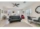 Spacious main bedroom featuring tile flooring, a ceiling fan, and a seating area at 2743 Evergreen Oaks Dr, Henderson, NV 89052