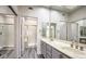 Bathroom with double sink vanity, large mirror, and separate shower enclosed with sliding glass doors at 2824 Dry Plains Dr, Las Vegas, NV 89134