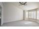 Primary bedroom features vaulted ceiling, ceiling fan, large windows, and neutral carpeting at 2824 Dry Plains Dr, Las Vegas, NV 89134