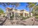 Exterior shot of a well-manicured home with desert landscaping and shuttered windows at 2824 Dry Plains Dr, Las Vegas, NV 89134