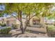View of home with stucco walls, tile roof, desert landscaping, and mature shade tree at 2824 Dry Plains Dr, Las Vegas, NV 89134