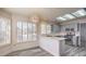 Eat-in kitchen features stainless appliances, abundant cabinetry, breakfast bar, and stylish pendant lighting at 2824 Dry Plains Dr, Las Vegas, NV 89134