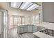 Spacious kitchen with gray cabinets, white countertops, stainless appliances, and modern lighting at 2824 Dry Plains Dr, Las Vegas, NV 89134