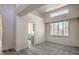 Bright living room featuring soaring ceilings, modern chandelier, and shuttered windows at 2824 Dry Plains Dr, Las Vegas, NV 89134