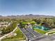 Stunning aerial view of the community entrance, showcasing lush landscaping and mountain views at 3 Glendora Ct, Henderson, NV 89052
