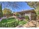 Beautiful backyard featuring a lush lawn, hot tub, fire pit, and outdoor kitchen under a clear blue sky at 3 Glendora Ct, Henderson, NV 89052
