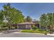 Well-maintained home surrounded by lush trees, complemented by an attached two-car garage, a neatly kept lawn, and inviting landscaping at 3 Glendora Ct, Henderson, NV 89052