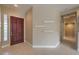 Inviting home foyer with sleek tile flooring, modern door, and decorative shelves at 3 Glendora Ct, Henderson, NV 89052