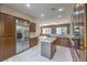Spacious kitchen with stainless steel fridge, granite island, and wood cabinetry offers a gourmet experience at 3 Glendora Ct, Henderson, NV 89052