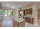 Bright kitchen showcases a granite island, stainless steel fridge, and wood cabinets for culinary excellence at 3 Glendora Ct, Henderson, NV 89052