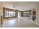 Spacious living room with tile floors, a ceiling fan, and sliding glass doors to the backyard at 3 Glendora Ct, Henderson, NV 89052