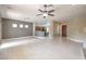 Open living area featuring tile flooring, ceiling fan, and seamless access to kitchen and front entrance at 3 Glendora Ct, Henderson, NV 89052