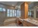 Luxurious main bathroom features a soaking tub, dual vanities, and walk-in shower for spa experience at 3 Glendora Ct, Henderson, NV 89052