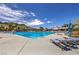 Sparkling community swimming pool with lounge chairs and umbrellas, ideal for summer relaxation at 3 Glendora Ct, Henderson, NV 89052