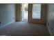 Spacious unfurnished living room with carpet and balcony access at 30 Strada Di Villaggio # 631, Henderson, NV 89011