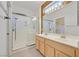 Well-lit bathroom with a glass shower, double vanity sinks, and modern fixtures at 3051 Scotts Valley Dr, Henderson, NV 89052