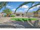 Charming single-story home with desert landscaping, mature palm trees, and a quaint front yard seating area at 3051 Scotts Valley Dr, Henderson, NV 89052