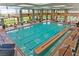 Bright indoor pool featuring lap lanes, lounge seating, and large windows with neighborhood views at 3051 Scotts Valley Dr, Henderson, NV 89052
