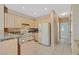 Charming kitchen featuring tile floors, light wood cabinets and granite countertops at 3051 Scotts Valley Dr, Henderson, NV 89052