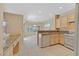 Functional kitchen featuring tile floors, light wood cabinets and granite countertops at 3051 Scotts Valley Dr, Henderson, NV 89052