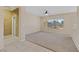 Bright, carpeted living room featuring a ceiling fan, a large window, and neutral toned walls at 3051 Scotts Valley Dr, Henderson, NV 89052