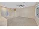 Spacious living room with tile entrance, carpeted area, neutral walls and a ceiling fan at 3051 Scotts Valley Dr, Henderson, NV 89052