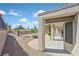 Covered patio area overlooking a serene backyard with desert landscaping, stone benches, and palm trees for outdoor enjoyment at 3051 Scotts Valley Dr, Henderson, NV 89052