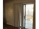 A close-up of a sliding glass door leading to a patio with vertical blinds at 3258 Glenhurst Dr, Las Vegas, NV 89121