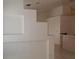 Hallway with tiled floors and neutral paint color is adjacent to a breakfast bar with tile surround at 33 Newburg Ave, North Las Vegas, NV 89032