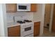 Kitchen with white appliances, wood cabinets, and white countertops at 33 Newburg Ave, North Las Vegas, NV 89032