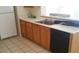 Kitchen featuring wood cabinets, white countertops, and appliances, ready for cooking at 33 Newburg Ave, North Las Vegas, NV 89032