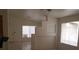 Open-concept living room with neutral paint, tiled floors, and lots of light from a window at 33 Newburg Ave, North Las Vegas, NV 89032