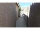 A side yard leads to a gated back entrance, providing privacy at 33 Newburg Ave, North Las Vegas, NV 89032