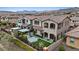 Overhead rear view of a home with outdoor pergola, artificial turf, and desert landscaping in a residential community at 342 Molinetto St, Las Vegas, NV 89138