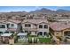 An elevated rear view of a well-maintained home featuring lush artificial turf and a charming pergola at 342 Molinetto St, Las Vegas, NV 89138