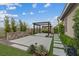 Backyard pergola seating area with modern landscaping and fence at 342 Molinetto St, Las Vegas, NV 89138