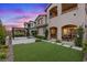 Home backyard featuring an outdoor patio, pergola, and synthetic grass at 342 Molinetto St, Las Vegas, NV 89138