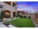 Well-maintained backyard with artificial grass and stone pathways, perfect for relaxation and outdoor activities at 342 Molinetto St, Las Vegas, NV 89138