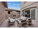 Outdoor patio with comfortable seating and a cozy brick fireplace for relaxing and entertaining at 342 Molinetto St, Las Vegas, NV 89138