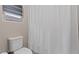 A bathroom with a toilet and white shower curtain at 342 Molinetto St, Las Vegas, NV 89138