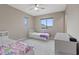 Bright bedroom with twin beds, neutral walls, and a ceiling fan at 342 Molinetto St, Las Vegas, NV 89138