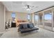 Bright bedroom featuring a ceiling fan, neutral walls, and sliding glass doors leading to a balcony at 342 Molinetto St, Las Vegas, NV 89138