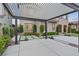 A driveway with a pergola, concrete tiles and small bushes, offering an aesthetic touch to the home's exterior at 342 Molinetto St, Las Vegas, NV 89138