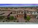 Charming two-story home in a desert setting, beautifully lit with a well manicured front lawn and landscape at 342 Molinetto St, Las Vegas, NV 89138