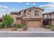 Lovely two-story home with a brick-accented facade, manicured landscaping, and a brick driveway at 342 Molinetto St, Las Vegas, NV 89138