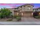 Charming two-story home with a brick-accented facade, a paved driveway, and a well-manicured front yard at 342 Molinetto St, Las Vegas, NV 89138